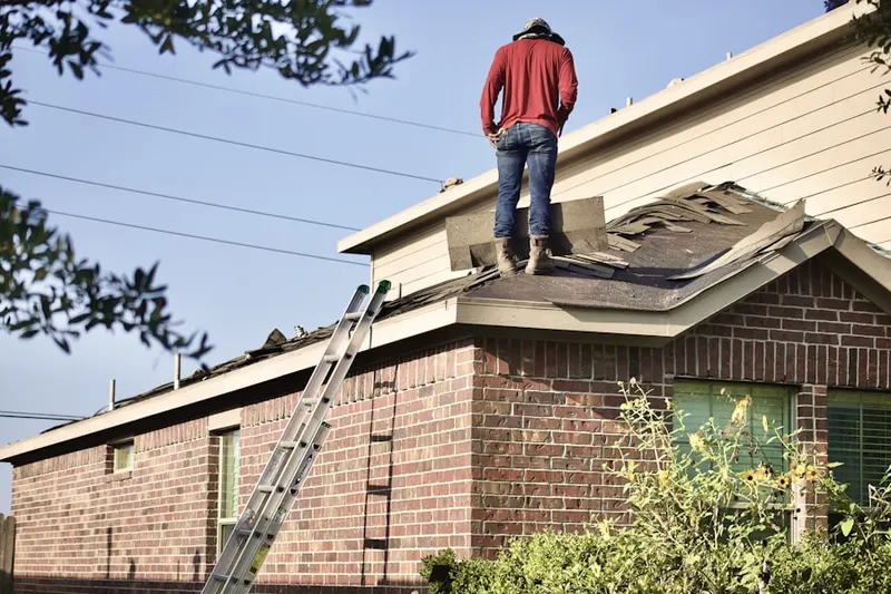 Professional roofer working on a residential roof in Batavia